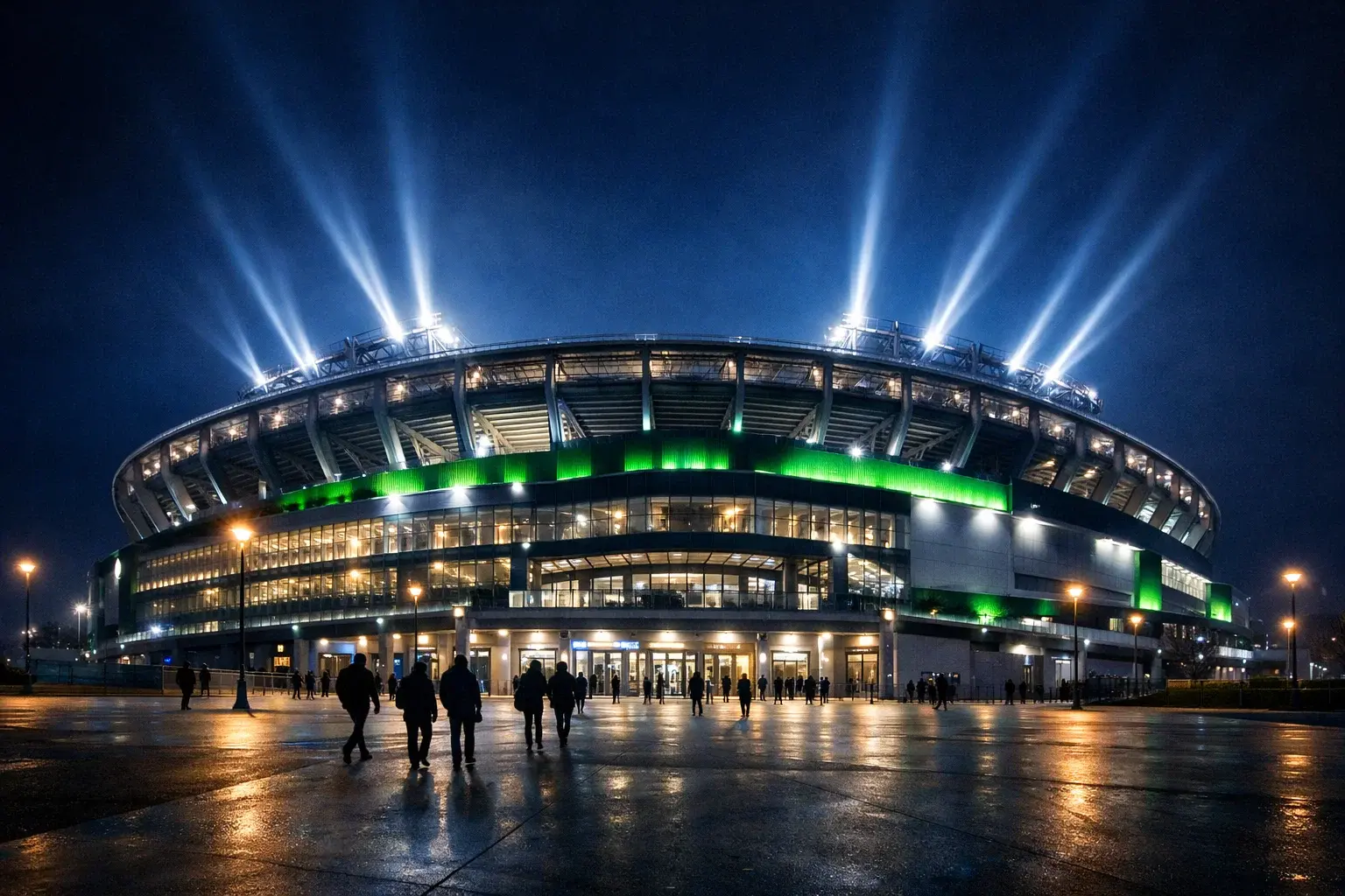 Veličasten pogled na osvetljen stadion z reflektorji med večerno nogometno tekmo